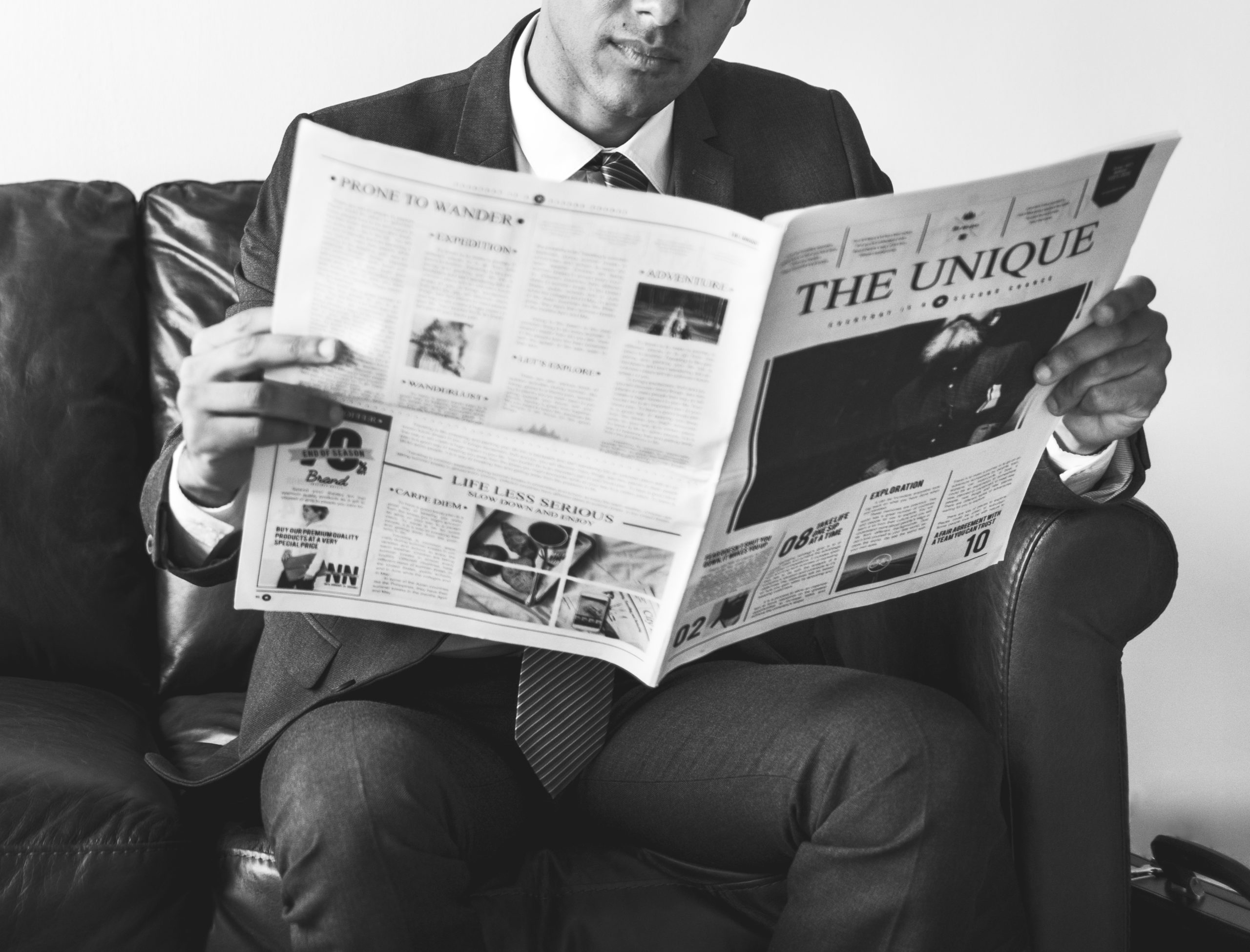 Businessman sitting and reading newspaper